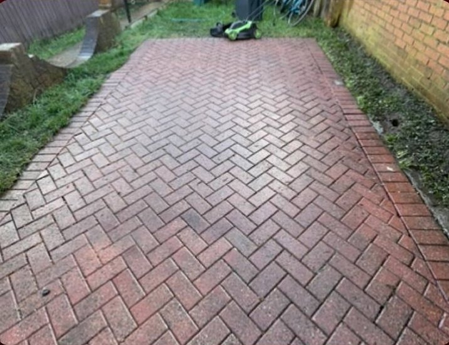 The same path jet washed back to clean red block paving